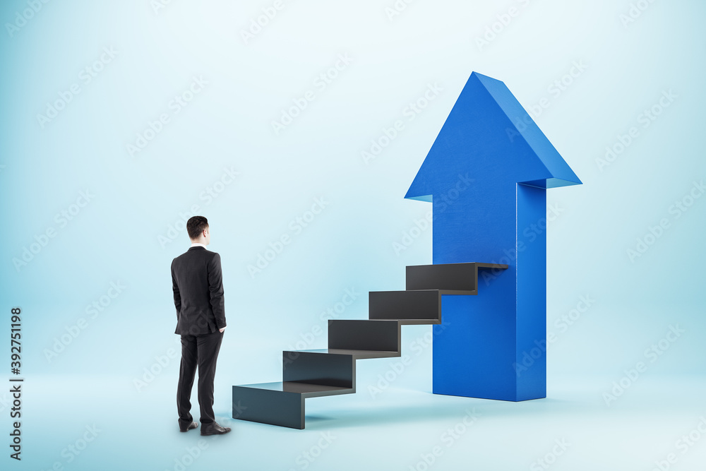 Businessman in suit looking on stairs with blue arrow. Businessman in suit looking on stairs with blue arrow.