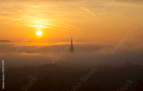 Cityscape of Graz with Church of the Sacred Heart of Jesus and historic buildings, in Graz, Styria region, Austria, at sunrise. Beautiful foggy morning over the city of Graz, in autumn © Aron M  - Austria