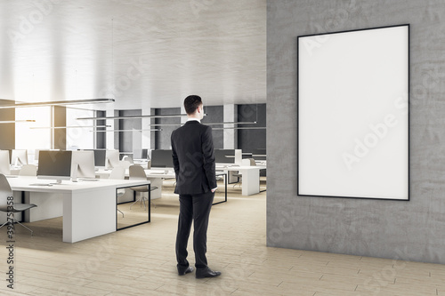 Businessman looking on blank poster