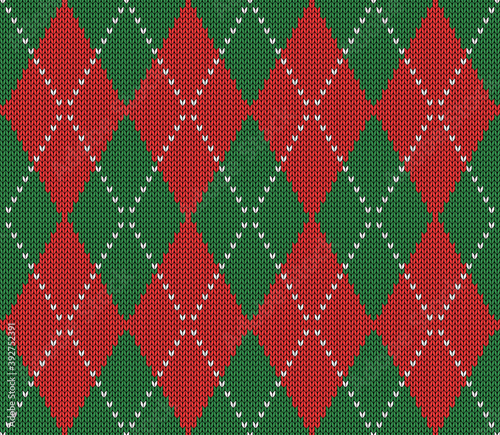 Knitted argyle Christmas and new year pattern. Wool knitinng. Scottish plaid in red and green rhombuses. Traditional  background of diamonds. Seamless fabric texture. Vector illustration