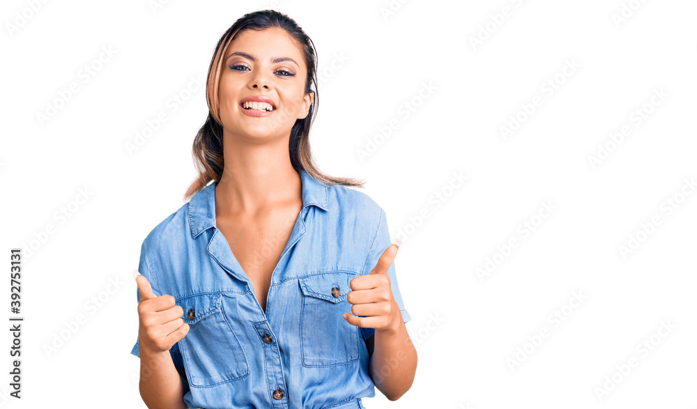 Young beautiful woman wearing casual clothes success sign doing positive gesture with hand, thumbs up smiling and happy. cheerful expression and winner gesture. Young beautiful woman wearing casual clothes success sign doing positive gesture with hand, thumbs up smiling and happy. cheerful expression and winner gesture.