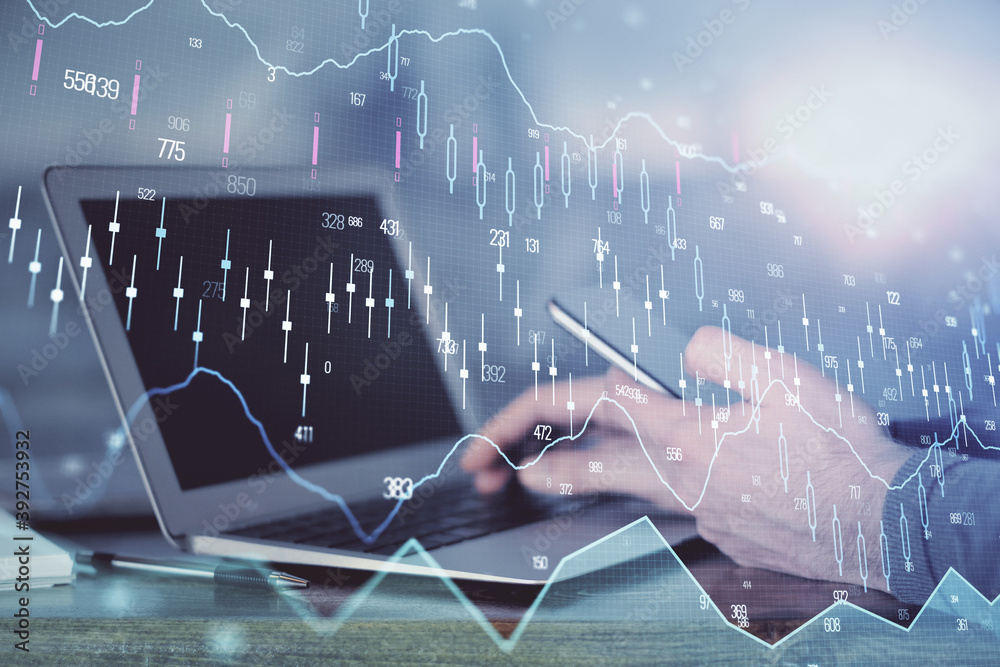 Double exposure of man's hands holding and using a digital device and forex graph drawing. Financial market concept.