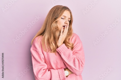 Beautiful young caucasian girl wearing casual clothes bored yawning tired covering mouth with hand. restless and sleepiness.