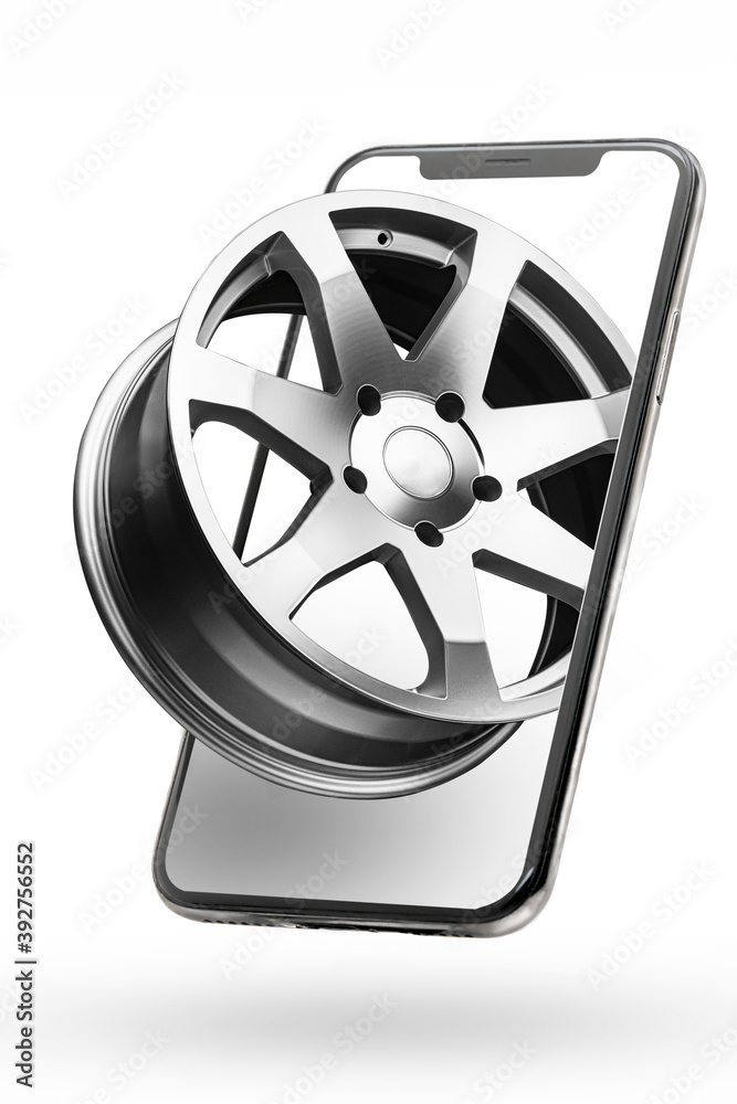 phone and alloy wheels, online delivery of auto parts and tires. Isolate on a white background vertical photo phone and alloy wheels, online delivery of auto parts and tires. Isolate on a white background vertical photo