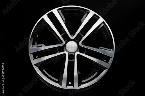new shiny alloy wheel  color black with silver front. Dark background  front view