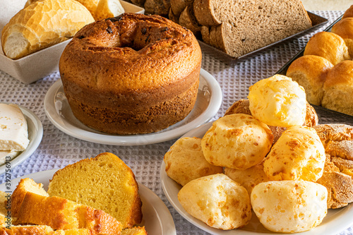 Breakfast table in hotel, with sweets, cakes, cheese bread and bread. Brazilian Mineira food and cuisine. photo