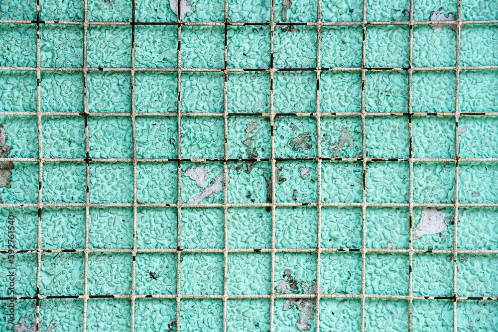 rusty grid on cement wall rusty grid on cement wall