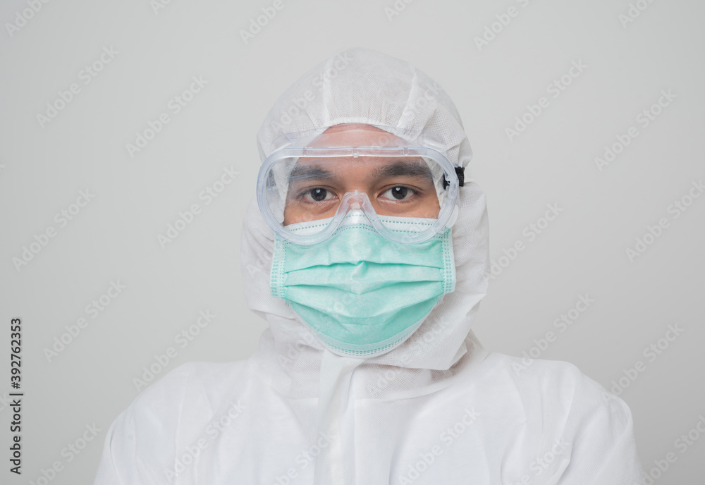 Close up A portrait of virologist Wearing PPE suit look into camera isolated on white background. Personal Protective Equipment Concept..