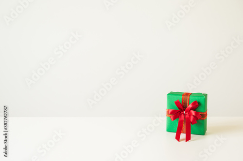 Gift box mockup on the white table with copy space. Merry christmas and happy new years background for text advertise.