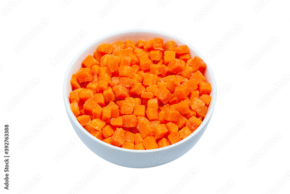 Top view of frozen diced carrots in a bowl on white background, close up