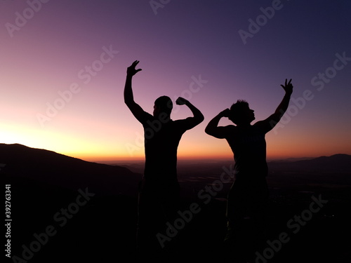 silhouettes of men and sunset