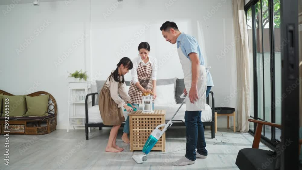 Asian family helping each other to clean the living room, Housework. Asian family helping each other to clean the living room, Housework.