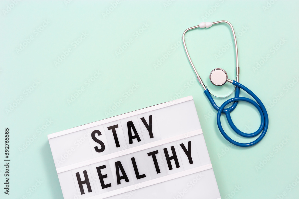 Healthcare and medical concept. Lightbox with words Stay Healthy and stethoscope. Health wishes. Healthcare and medical concept. Lightbox with words Stay Healthy and stethoscope. Health wishes.