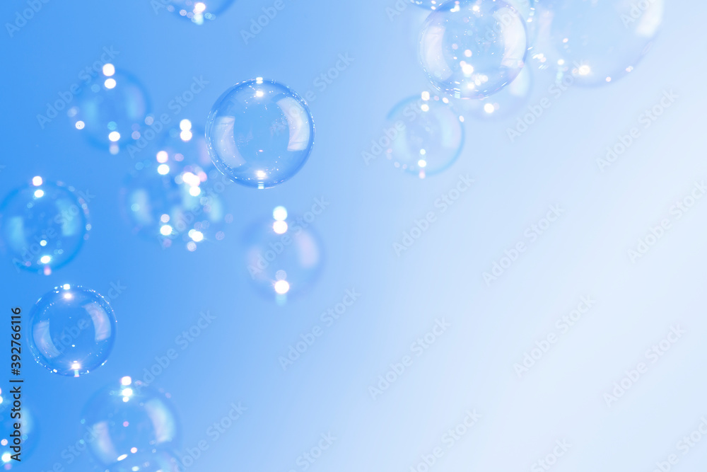 Beautiful shiny soap bubbles float on a blue background with copy space. Abstract, Celebration, Natual fresh summer, Chrimas holiday soft blue texture. Beautiful shiny soap bubbles float on a blue background with copy space. Abstract, Celebration, Natual fresh summer, Chrimas holiday soft blue texture.