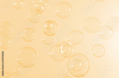 Beautiful shiny transparent soap bubbles float on yellow texture background. Abstract, Celebration, Natual fresh summer, Chrimas holiday background. photo