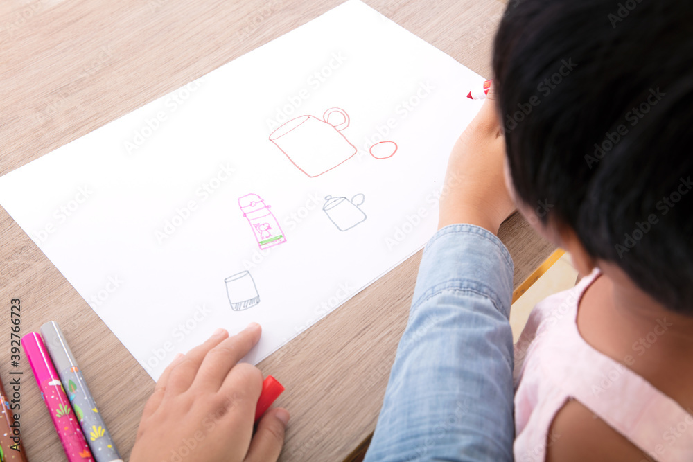 The child’s mother or preschool teacher is teaching a child to draw simple strokes The child’s mother or preschool teacher is teaching a child to draw simple strokes