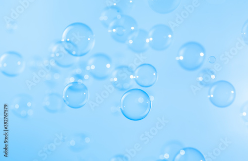 Abstract  Blue soap bubbles floating in the air. Natural freshness summer holiday background.