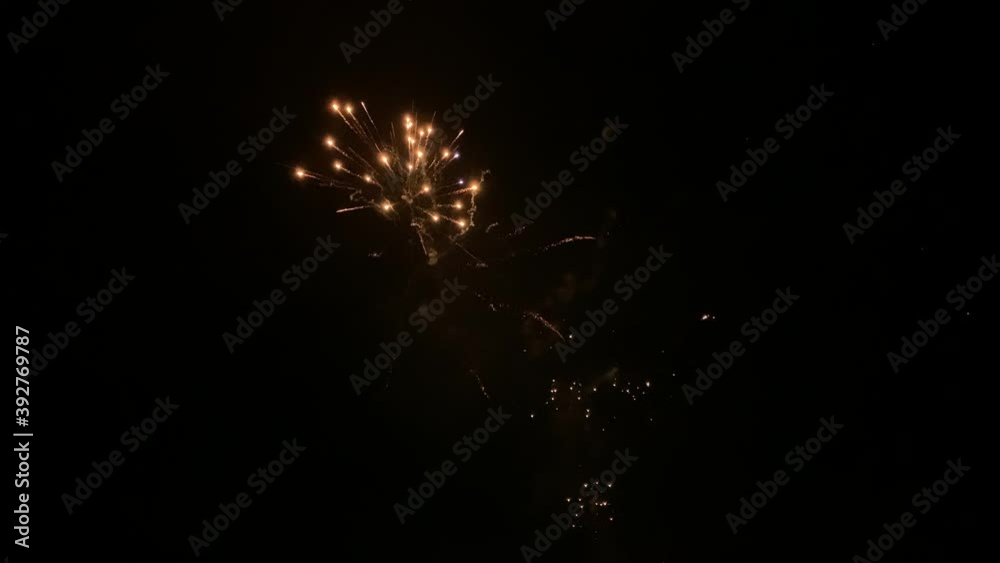 Colourful fireworks show exploding against dark night sky Colourful fireworks show exploding against dark night sky