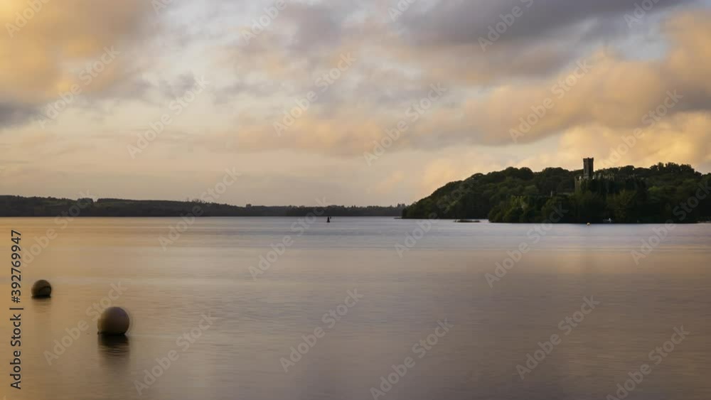 Time lapse of a castle ruin on lake horizon during sunset evening in Ireland. Time lapse of a castle ruin on lake horizon during sunset evening in Ireland.