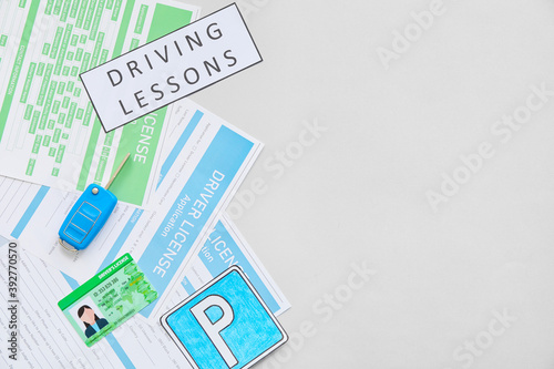 Driving license with application forms and car key on white background photo