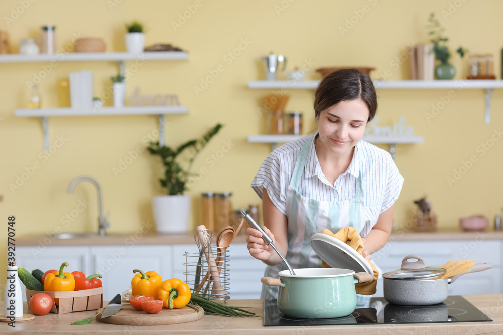 Woman cooking dinner in kitchen