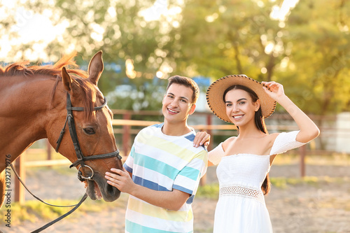 Young couple with cute hors...