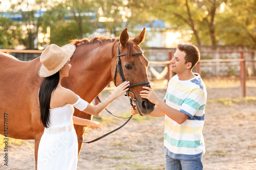 Young couple with cute hors...