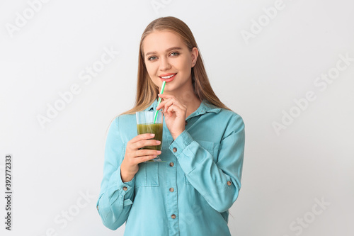 Young woman with wheatgrass...