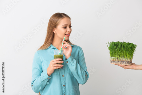 Young woman with wheatgrass...