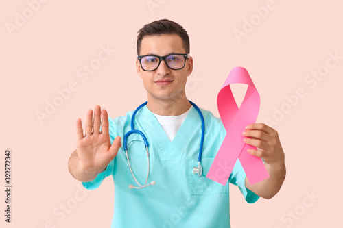 Doctor with pink ribbon on ...