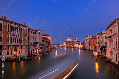 Long exposure of a boat traveling down the Grand Canal in Venice, Italy at twilight