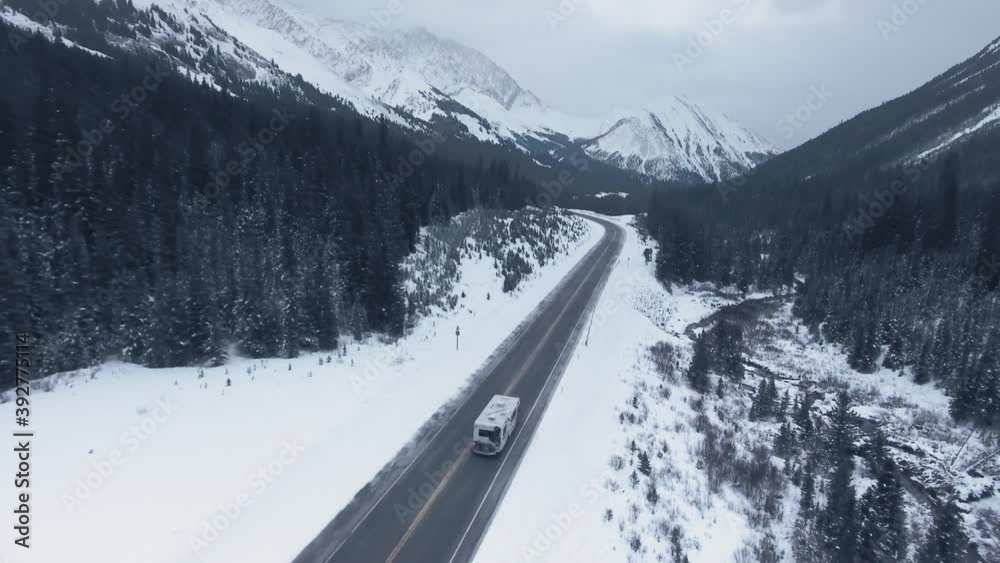 Drone chasing RV crossing the continent through high mountains and ...