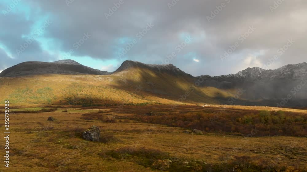 drone flying in norway with clouds and mountains.