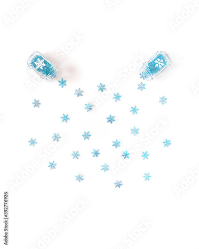 Winter concept. Snowflakes fly out of a glass jar with a handle. Template for Christmas, New Year, banner. Flat lay, top view.