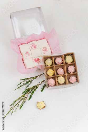 Composition of sweets packed in boxes three in a row. Top view. photo