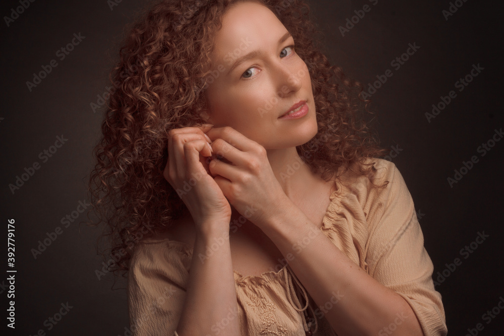 Studio portrait of a young woman with curly hair Studio portrait of a young woman with curly hair