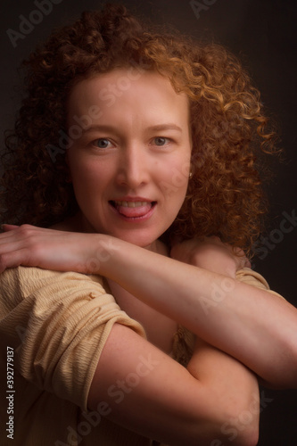 Studio portrait of a young woman with curly hair