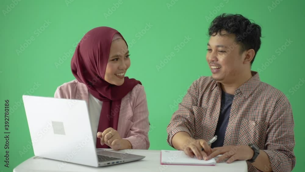 muslim man and woman partner discussing over green screen muslim man and woman partner discussing over green screen
