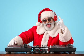 Cool Santa DJ playing music on color background