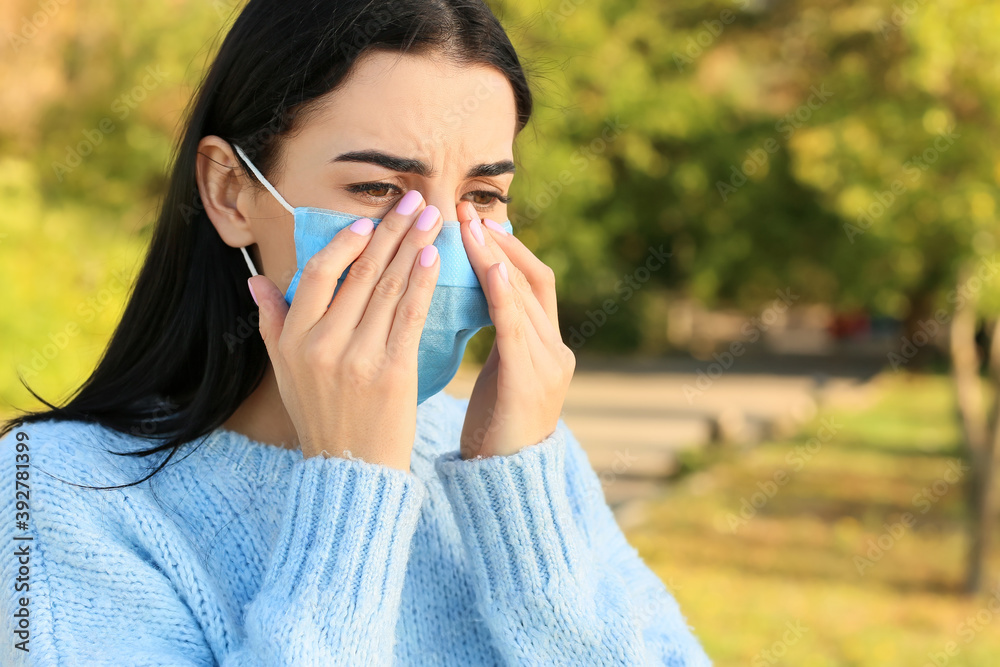 Young woman suffering from allergy outdoors Young woman suffering from allergy outdoors