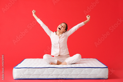 Happy young woman sitting o...