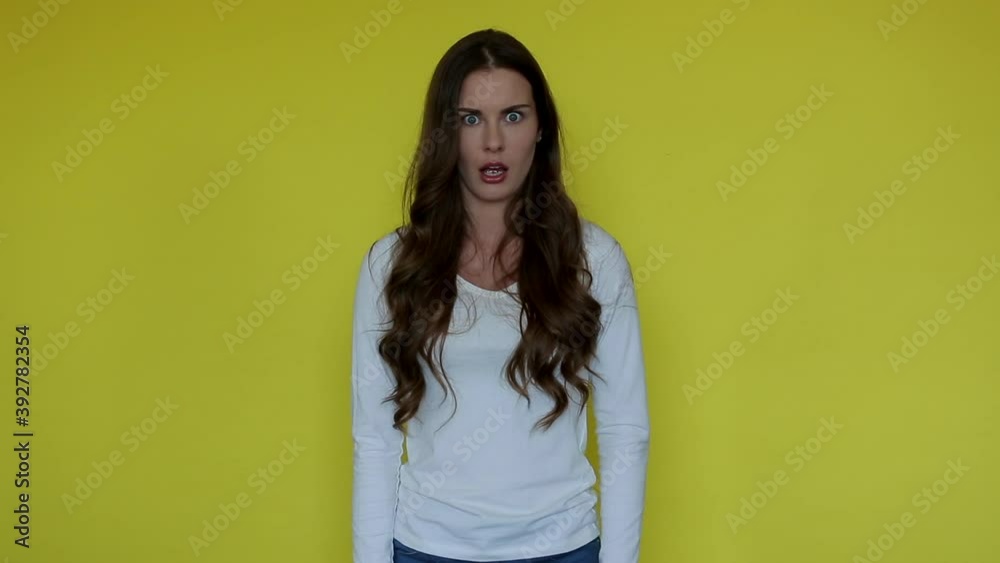 Shock woman face in yellow background. Surprise girl emotion isolated. Female portrait enjoy amazed sale. Attractive person wonder look. Scared lady open mouth Shock woman face in yellow background. Surprise girl emotion isolated. Female portrait enjoy amazed sale. Attractive person wonder look. Scared lady open mouth