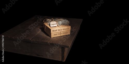 Lagom, Swedish concept of balanced lifestyle. Christmas craft box on a rustic table. photo
