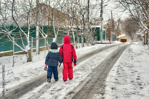 Children in warm jackets on a walk on a winter day