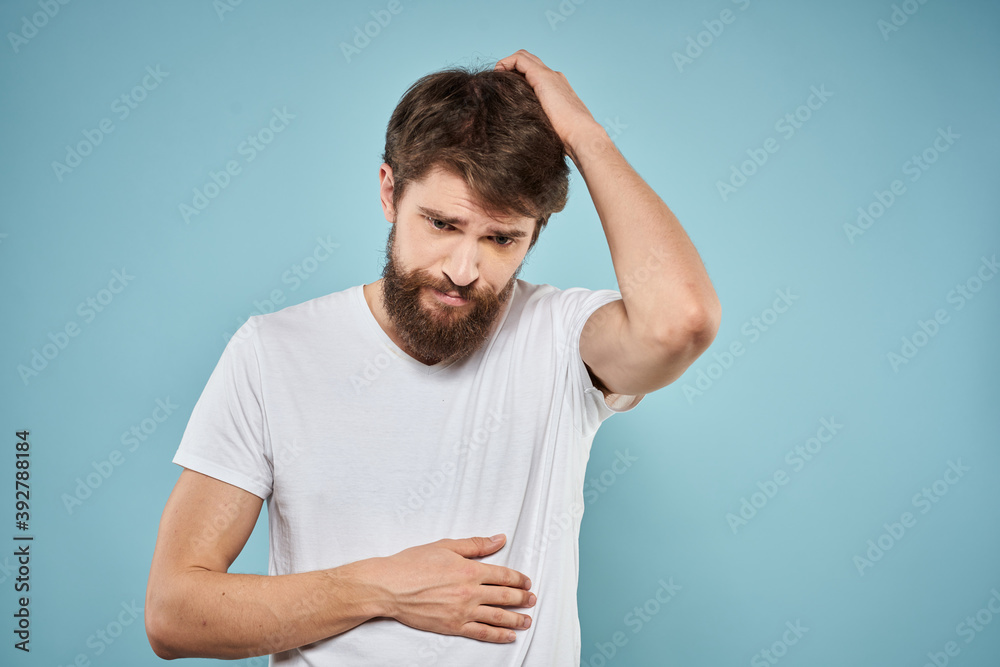 Man in white t-shirt emotions facial expression cropped view studio blue background lifestyle Man in white t-shirt emotions facial expression cropped view studio blue background lifestyle