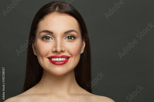 Beautiful smiling woman on black background portrait
