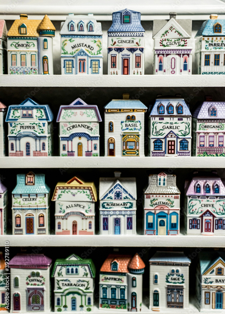 Naklejka premium Grandmothers vintage kitchen spices shelf tools for cooking in old house formed porcelain containers
