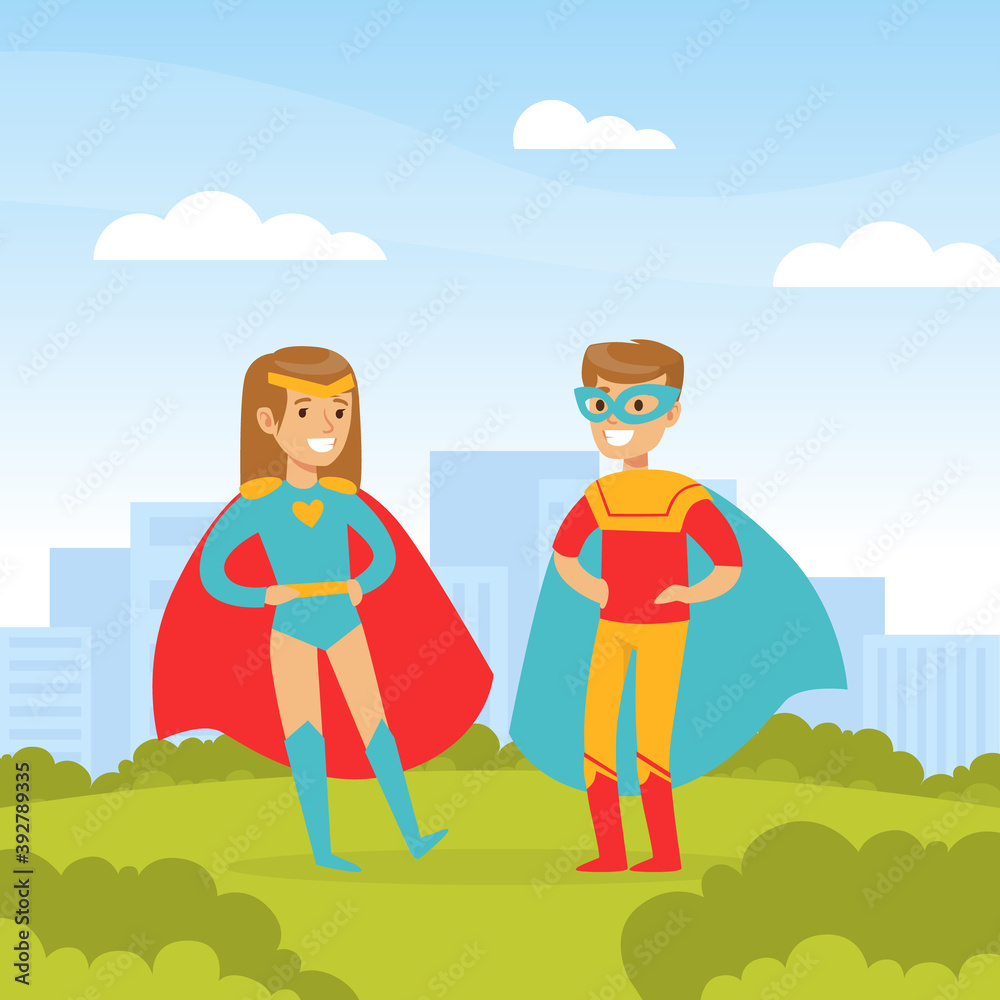 Cute Boy and Girl Dressed in Superhero Costumes Playing Outdoors, Happy Kids Having Fun on Background of City Landscape Cartoon Vector Illustration