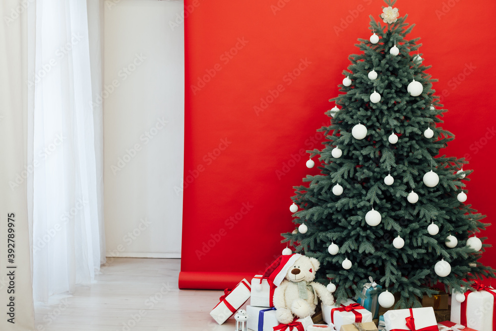 Fototapeta premium New Year's card interior red decor and Christmas tree with gifts