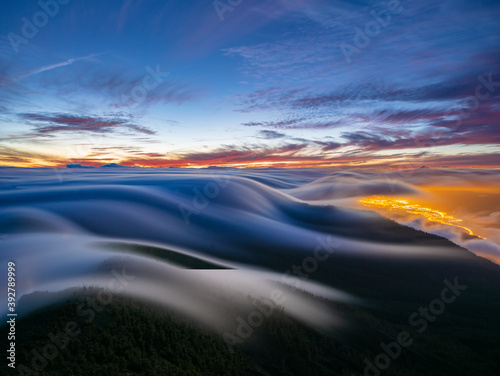 The famous "cloudy waterfalls" seen from the caldera of the Teide volcano in Tenerife at sunrise